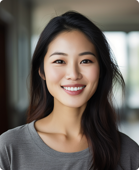 A young woman with long dark hair smiles at the camera